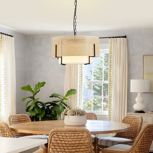 Dining room with round table, wicker chairs, and a pendant light fixture.