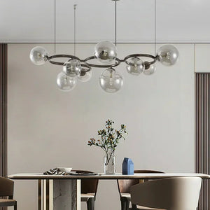 Modern chandelier hanging above a dining table with a neutral background