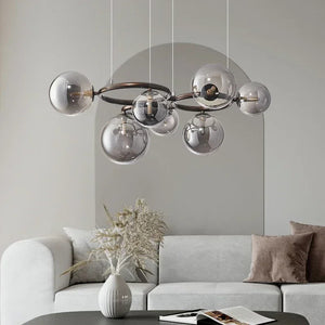 Modern chandelier with glass shades in a living room setting.
