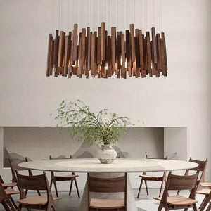 Modern dining room with a large wooden pendant light, round table, and chairs.