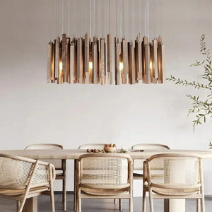 Modern dining room with wooden pendant light fixture, table, and chairs.