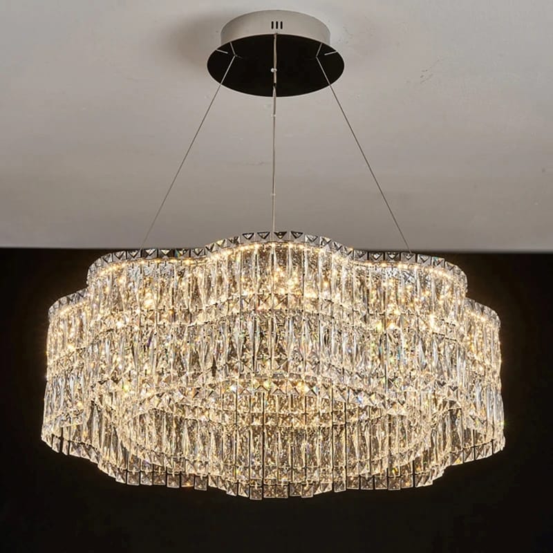 Crystal chandelier hanging from the ceiling with a dark background