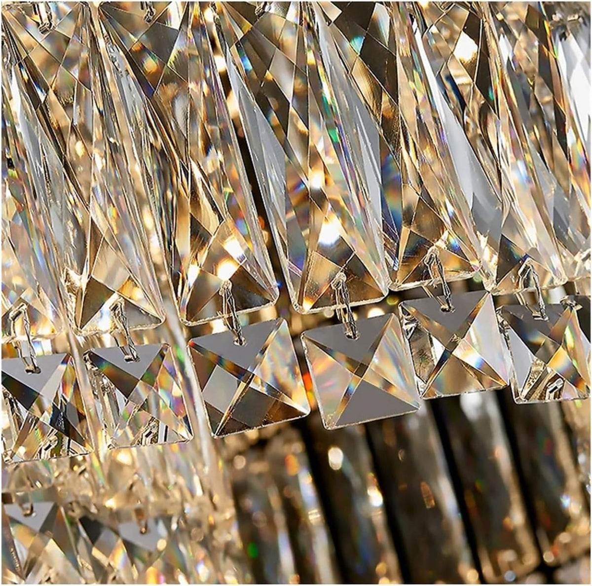 A close-up of a hanging crystal chandelier with faceted clear glass prisms and triangular crystal drops reflecting warm light.
