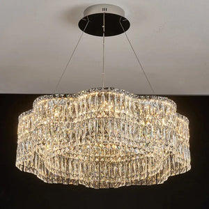 Crystal chandelier hanging from the ceiling with a dark background