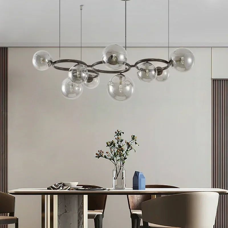 Modern chandelier hanging above a dining table with a neutral background
