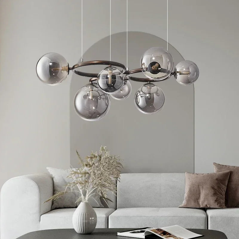 Modern chandelier with glass shades in a living room setting.
