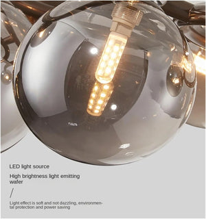 Close-up of a modern ceiling light fixture with reflective glass shades.