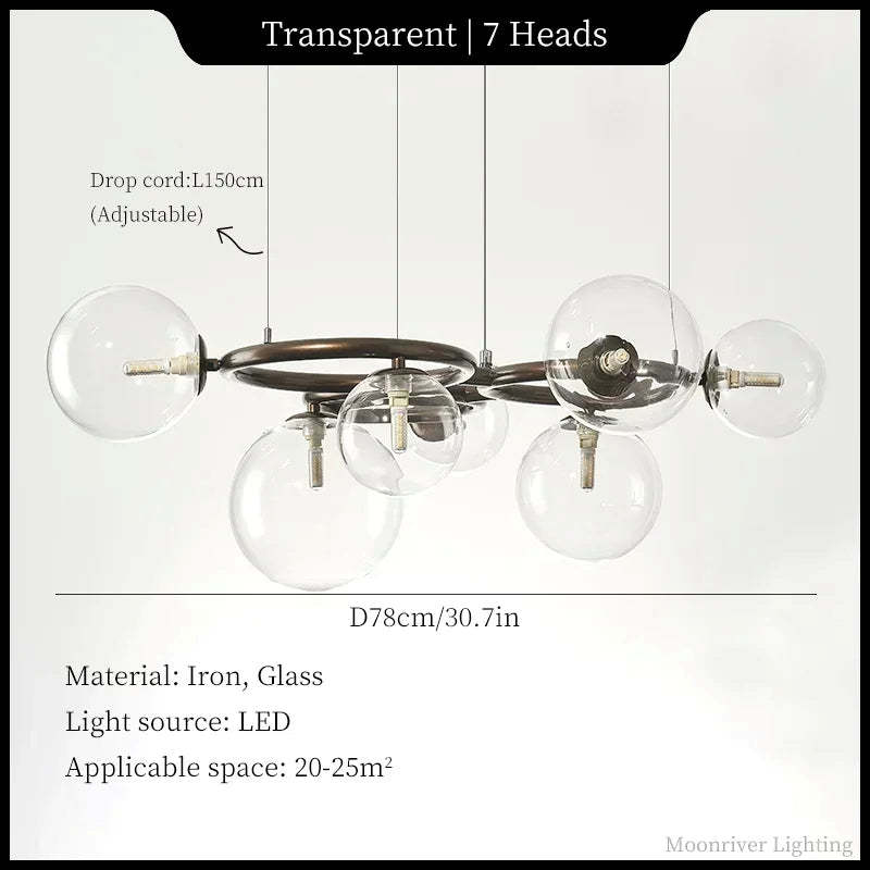 A 7-head transparent glass globe chandelier with an industrial iron frame, shown with dimension lines and text detailing its drop cord length, overall width, material, and LED light source against a white background.
