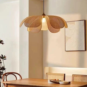 Woven pendant light hanging above a dining table with a neutral color scheme.
