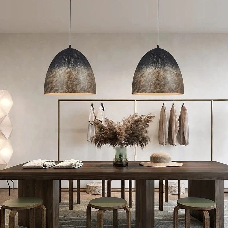 Dining room with wooden table, stools, and pendant lights.