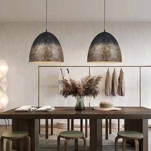 Dining room with wooden table, stools, and pendant lights.