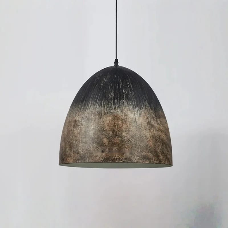 A dome-shaped pendant light with a distressed metallic finish, featuring a dark top that fades into a textured bronze and brown pattern at the bottom, suspended by a thin black cord against a light gray background.