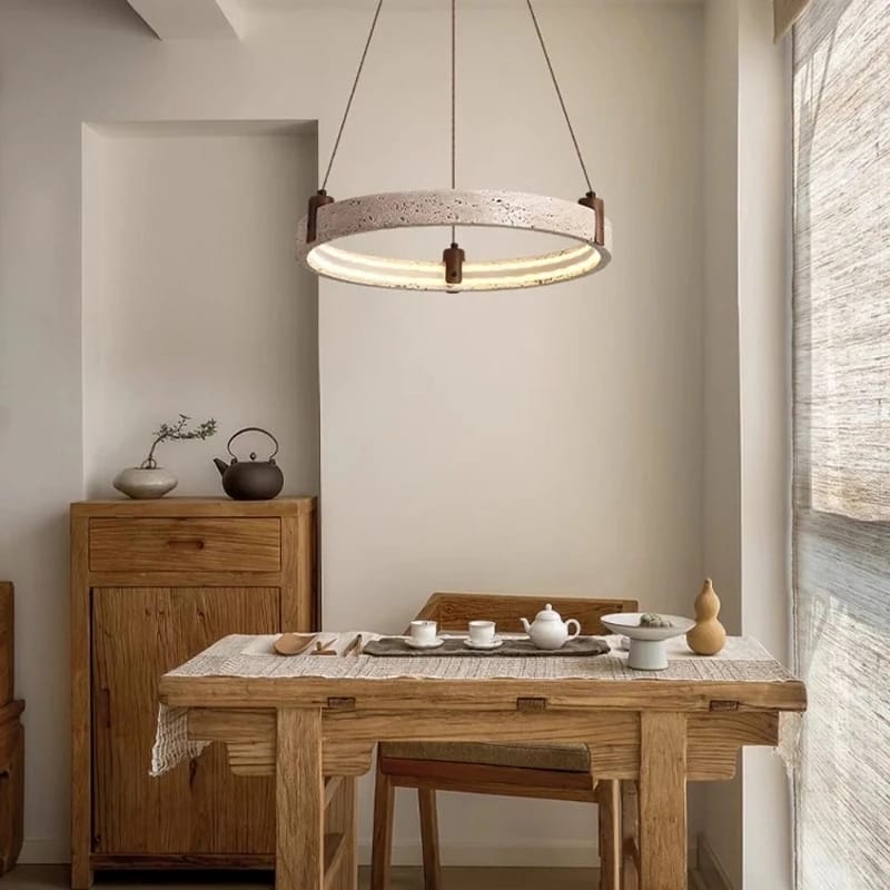Dining area with wooden table, chairs, and a hanging light fixture.