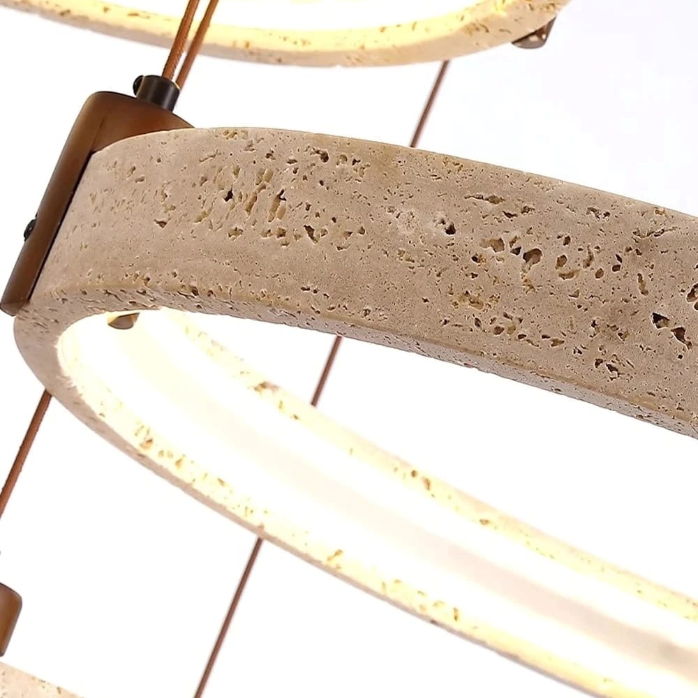 Close-up of a light fixture with concrete base and brass accents on a white background