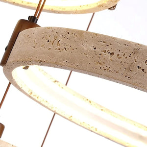 Close-up of a light fixture with concrete base and brass accents on a white background