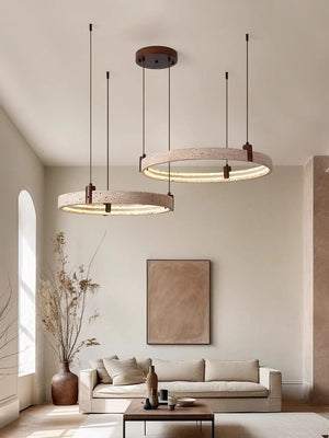 Modern living room with pendant lights, sofa, and decorative elements.