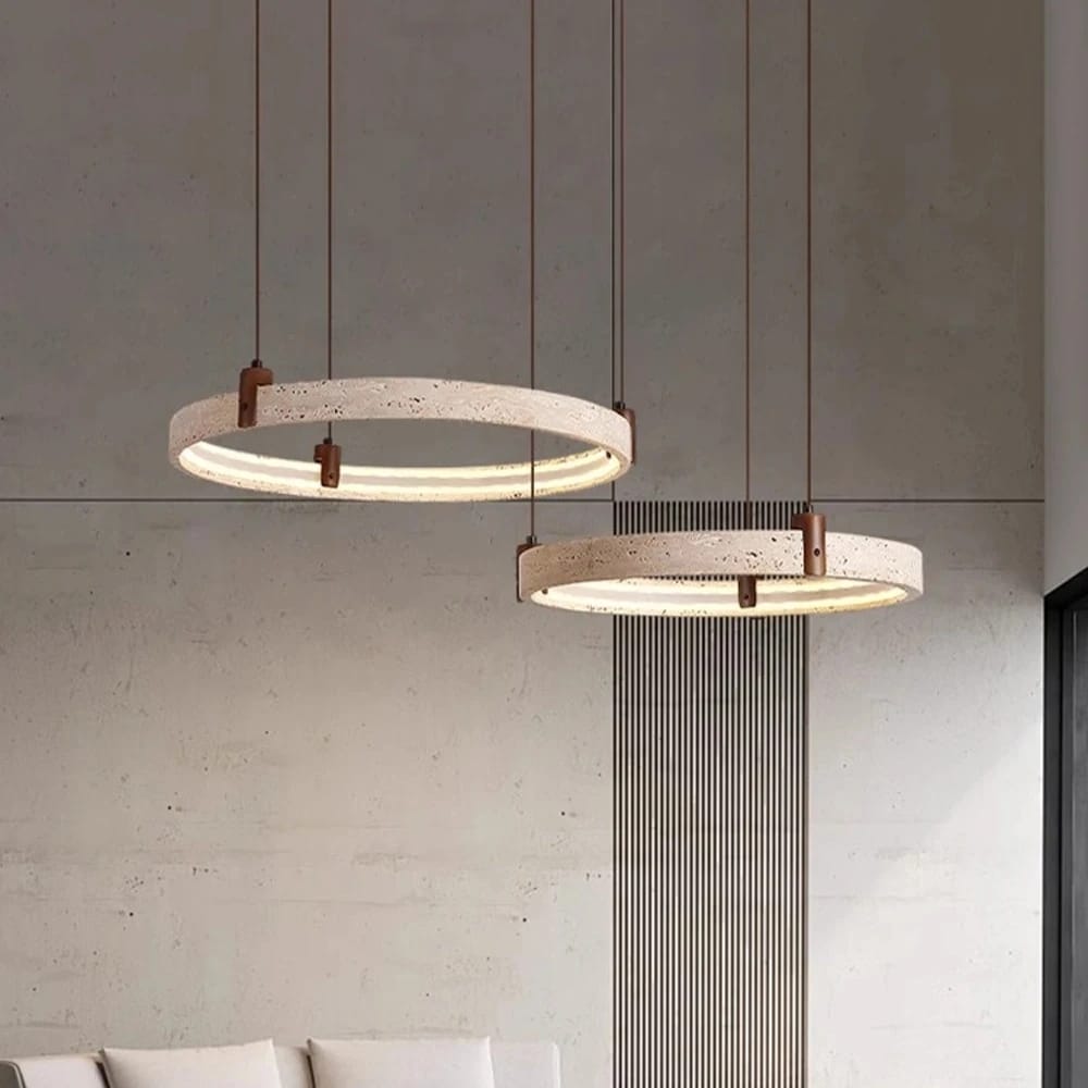 Two modern pendant lights hanging from the ceiling with a neutral background.