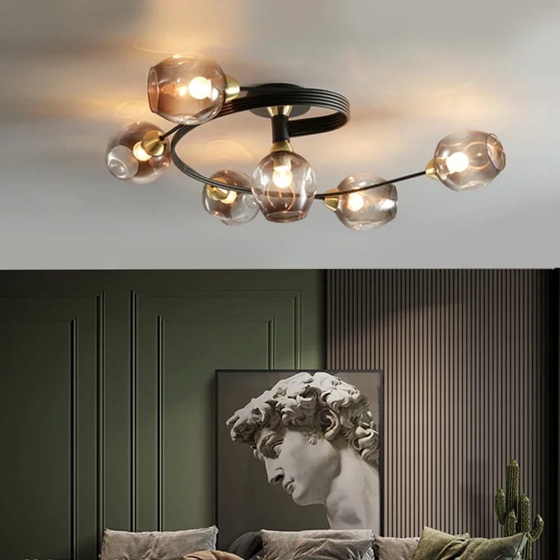 Modern ceiling light fixture with glass shades in a room with a sculpture and artwork.