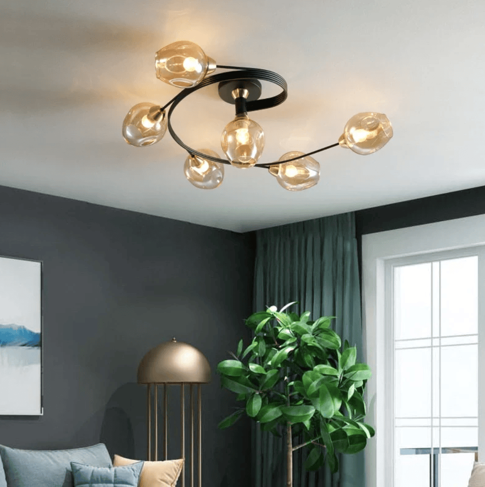 Modern semi-flush mount ceiling light fixture with a black circular frame and six clear glass globe shades, illuminated in a contemporary living room setting.