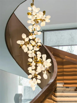 Chandelier hanging above a staircase with a modern interior design.