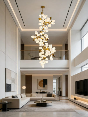 Modern living room with a large chandelier, sofa, and coffee table.