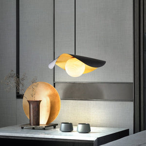 Modern table lamp with a unique design on a gray surface.