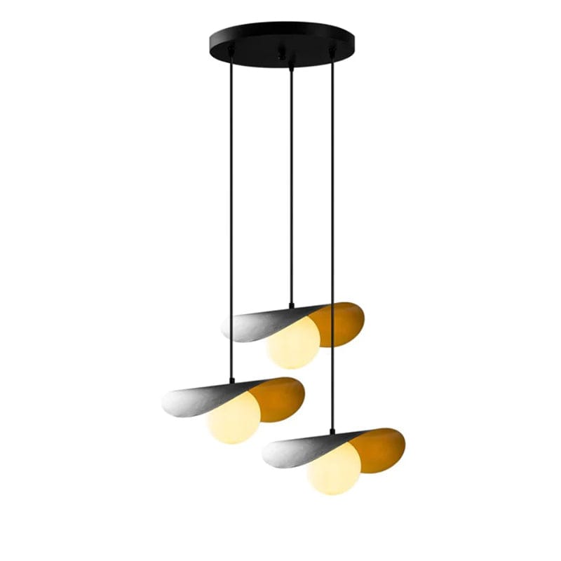 Modern multi-light pendant chandelier with four curved amber glass shades and black metal hardware, suspended from a circular black ceiling canopy against a white background.