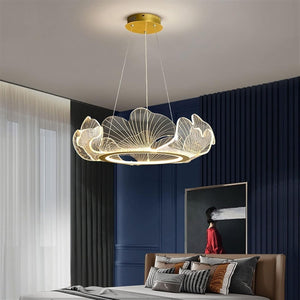 Modern chandelier hanging in a bedroom with a blue wall and bed.
