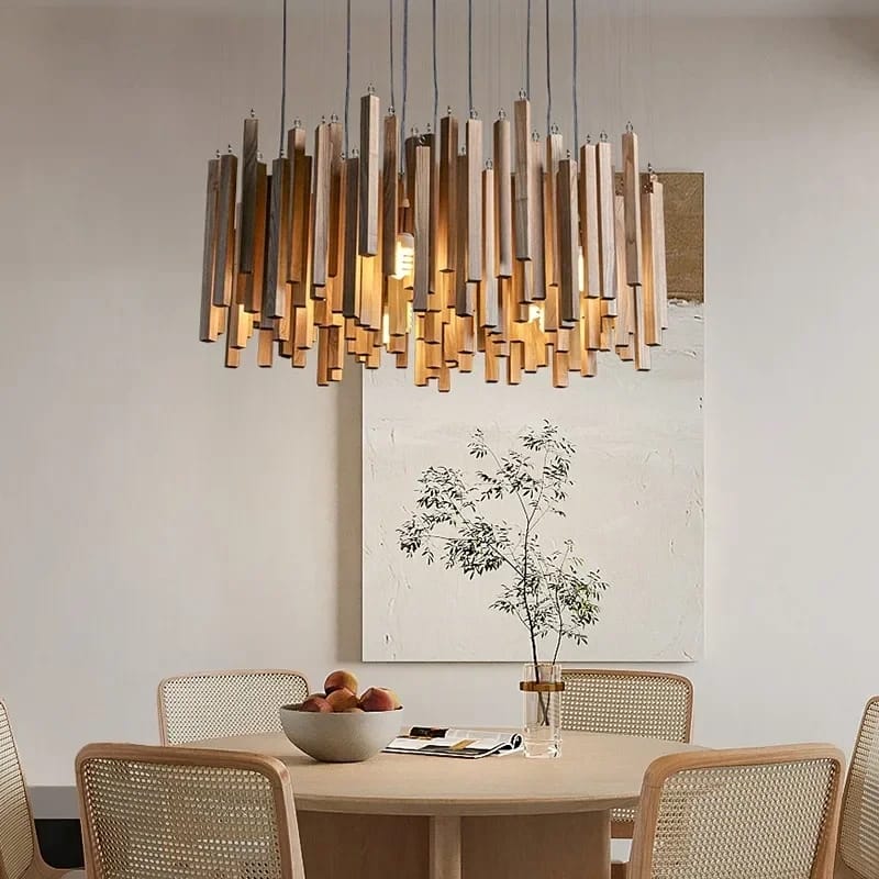 Dining room with a modern chandelier, table, chairs, and decor.