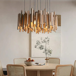 Dining room with a modern chandelier, table, chairs, and decor.